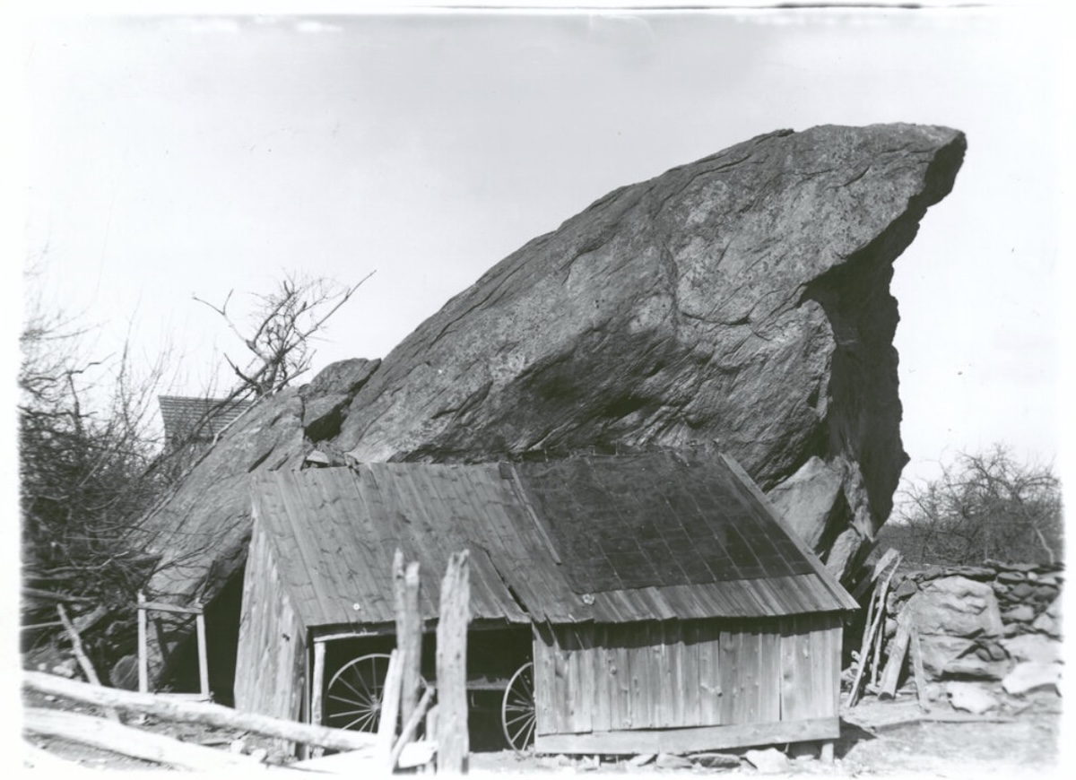 Historic 1901 photograph of Indian Rock, a massive glacial boulder beside a barn on Sylvester Hallock's farm in Rocky Point, Long Island.